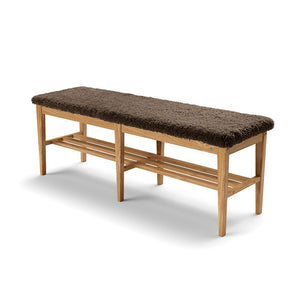 Hallbänk i ek med brun ullig stoppning och underliggande hyllplan för skoförvaring