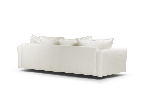 Vit soffa med löstagbara kuddar, vy bakifrån som visar rena linjer och modern design