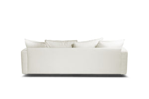 Vit soffa med lösa kuddar i linnetyg, vy framifrån mot vit bakgrund