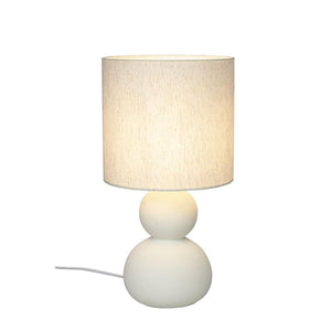 Bordslampa med beige linneskärm och vit keramikfot i två runda sfärer