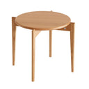 Runt bord i ljust trä med tre ben och minimalistisk skandinavisk design