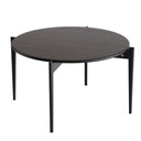 Runt soffbord i mörkt trä med svarta metallben i modern skandinavisk design