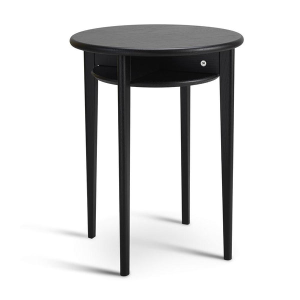 Runt svart sidobord med låda och tre ben i trä