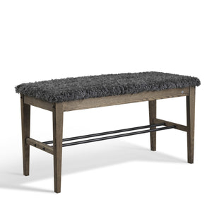 Hallbänk med grå fluffig sits och träben i mörkbrun ek med metallhylla för skoförvaring