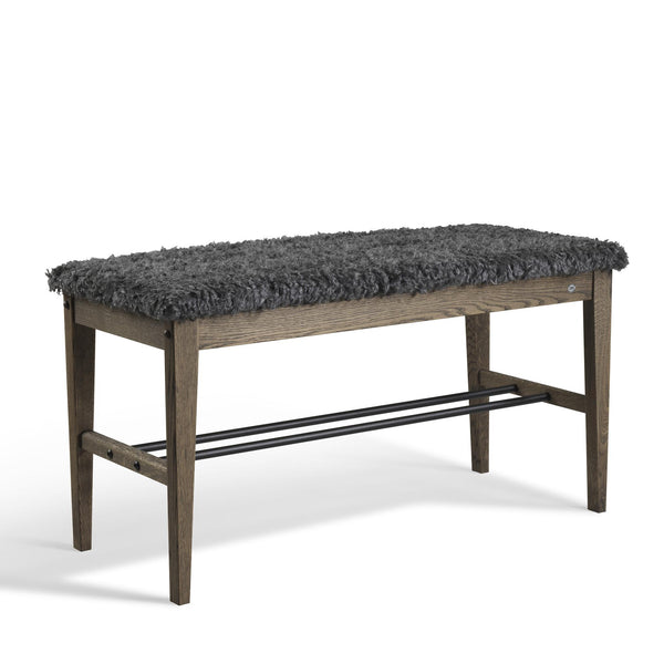 Hallbänk med grå fluffig sits och träben i mörkbrun ek med metallhylla för skoförvaring