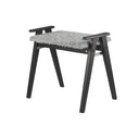 Grå pall med luddig sits och svarta träben, perfekt som fotpall eller extra sittplats