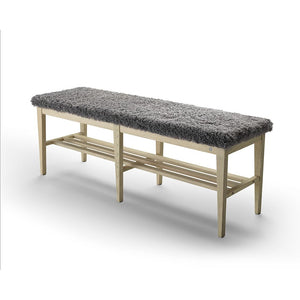 Bänk med ljust trästomme och grått fårskinnssäte, praktisk förvaring under sitsen