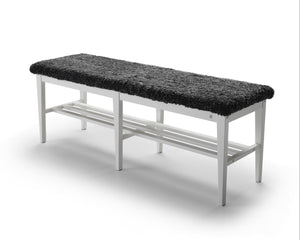 Bänk med svart fårskinnssits och vit metallram samt hylla för skor under sittdelen