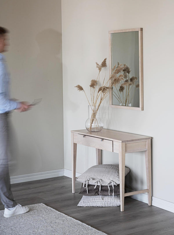 Hallmöbel i ljust trä med spegel, låda och hylla, dekorerad med torkade blommor i glasvas