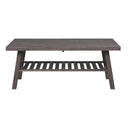 Grått soffbord i trä med avlastningshylla och snedställda ben i modern skandinavisk design