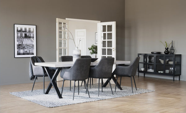 Matgrupp med vitt bord, grå stolar och svart skåp i modern matsal med ljust trägolv