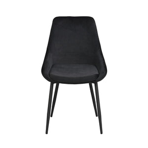 Svart matstol med sammetsklädd sits och rygg samt svarta metallben i modern design