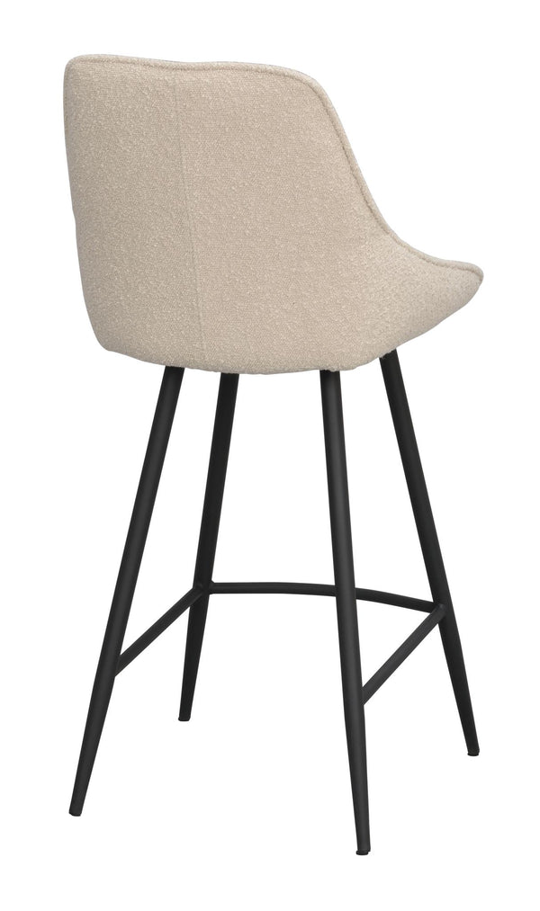 Barstol med beige klädsel och svarta metallben, sedd bakifrån