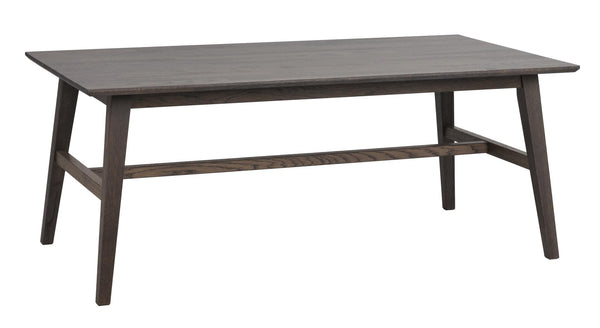 Mörkgrått matbord i trä med snedställda ben och genomgående hylla mellan benen