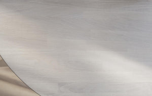 Ljusgrå plywoodskiva med naturlig trästruktur och synliga årsringar, lämplig för möbler och inredning