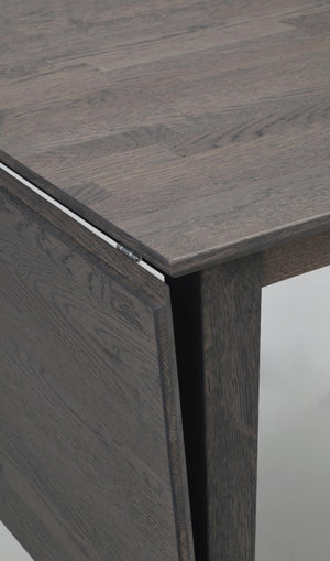 Närbild på gråbrun träskiva med synlig trästruktur och elegant foge mellan skiva och sidopanel