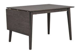 Grått matbord i trä med klaffar och snedställda ben i modern skandinavisk design