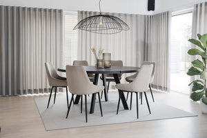 Matgrupp med runt svart bord och sex beige stolar i modern matsal med grå gardiner och ljust trägolv