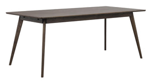Rektangulärt matbord i mörkbrun ek med sneda ben i modern skandinavisk design