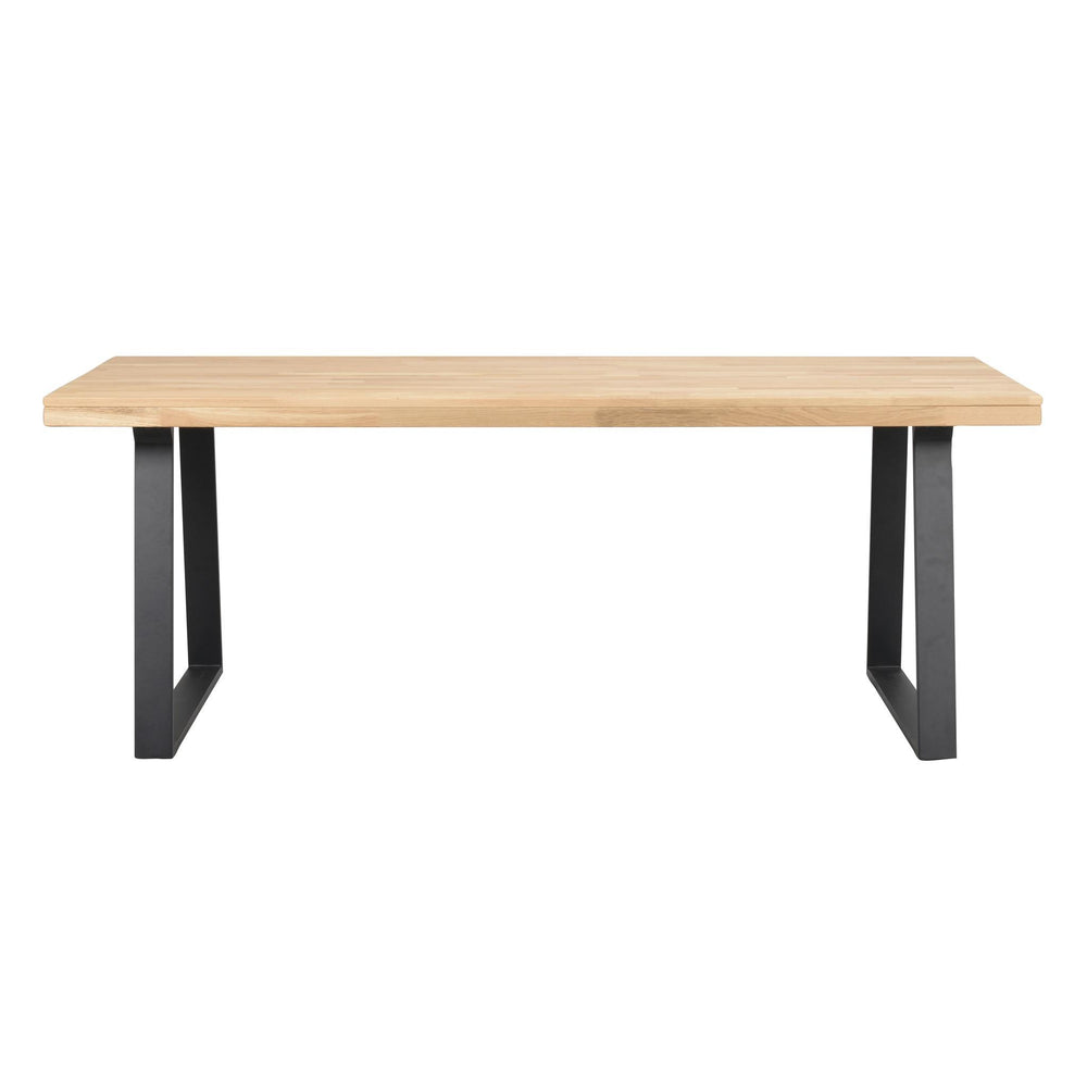 Matbord med ljus ekfanér skiva och svarta U-formade metallben i modern skandinavisk design