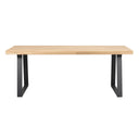 Matbord med ljus ekfanér skiva och svarta U-formade metallben i modern skandinavisk design