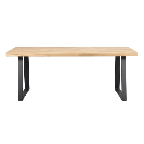 Matbord med ljus ekfanér skiva och svarta U-formade metallben i modern skandinavisk design