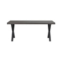 Matbord med grå träskiva och svarta korslagda metallben i modern industriell stil