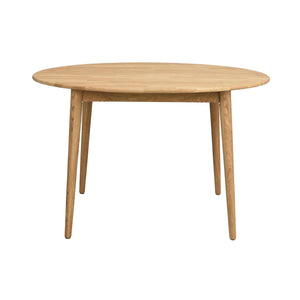 Runt matbord i ljust trä med fyra vinklade ben och enkel skandinavisk design