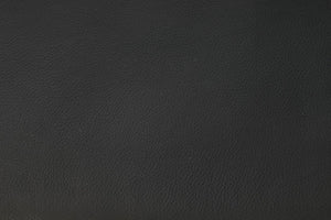 Mörkgrå texturerad konstläderyta med naturligt skinnmönster, närbild av materialet