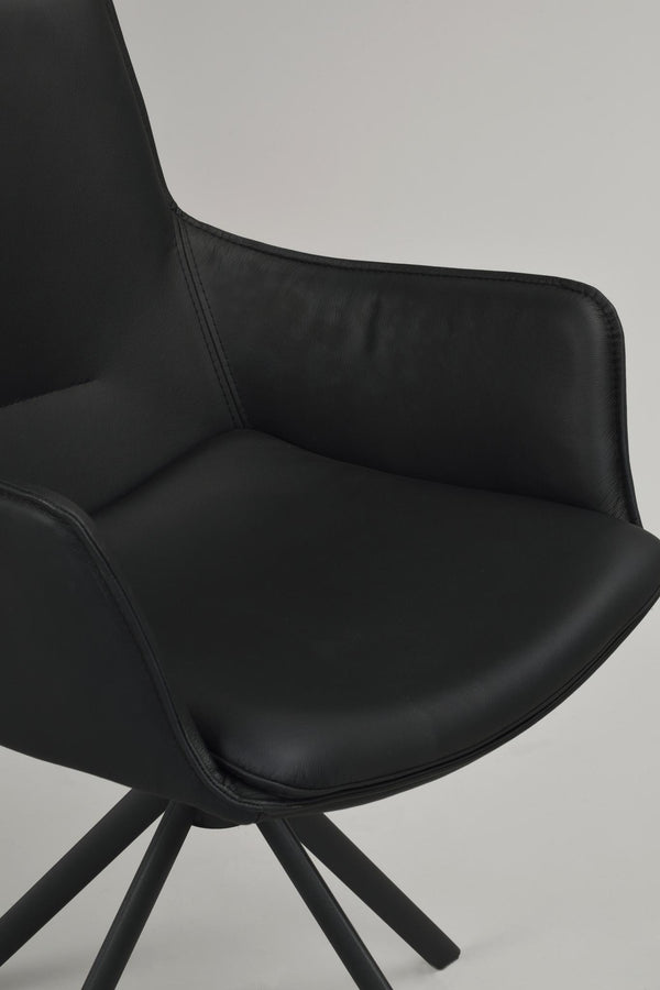 Svart stoppad stol med hög rygg och träben i spindeldesign, närbild på sits och ryggstöd