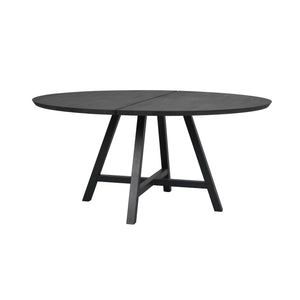 Runt matbord i svart trä med avtagbar mittdel och fyra snedställda ben i modern design