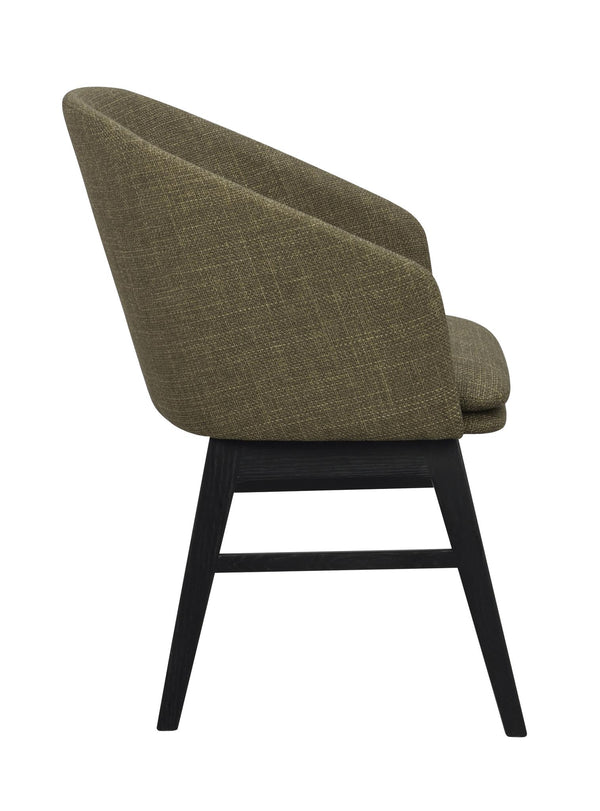 Grön stoppad stol med svarta träben, sidovy som visar kurvad rygg och modern design