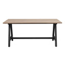 Matbord med ljus träskiva och svarta metallben i industriell stil