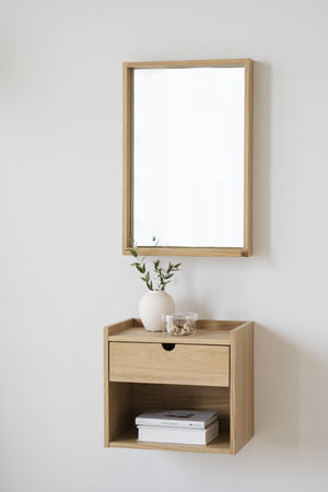 Väggmonterad sängbord i ljust trä med spegel, låda och öppen hylla i minimalistisk skandinavisk stil
