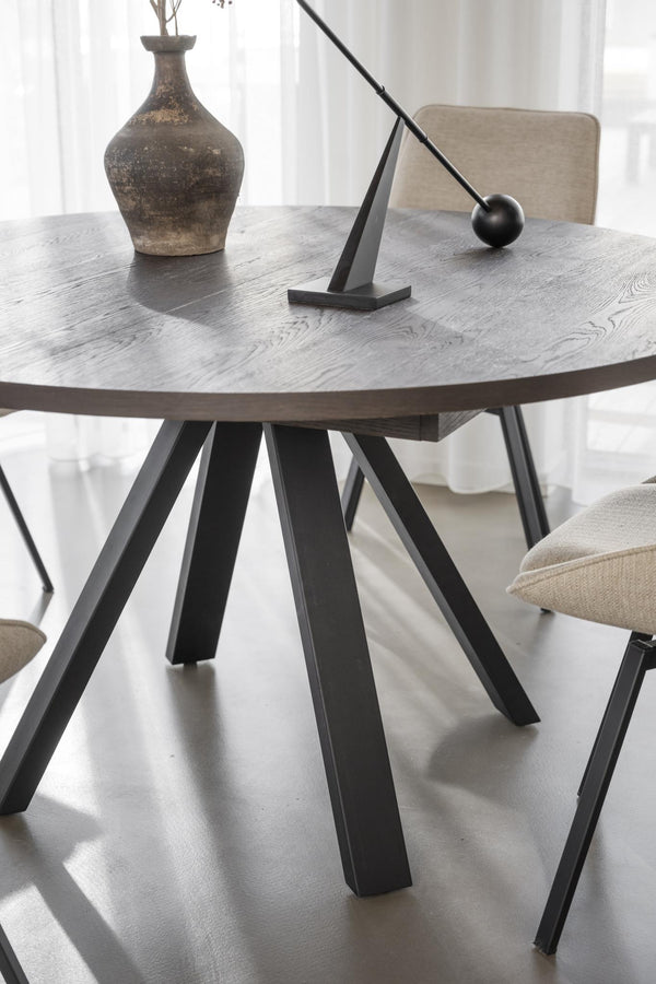 Runt matbord med grå träskiva och svarta metallben i modern skandinavisk design
