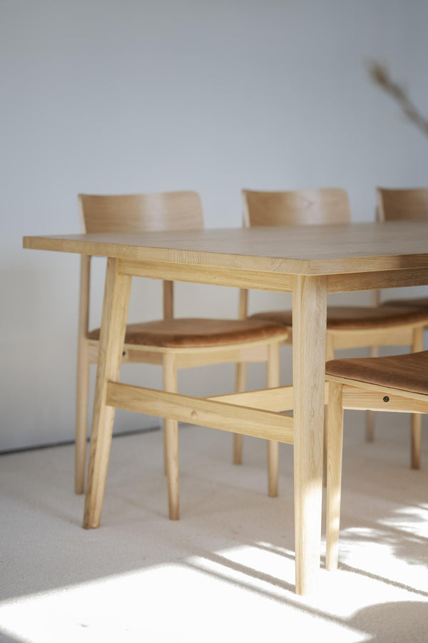 Matbord i ljust trä med matchande stolar i modern skandinavisk design för matsalen