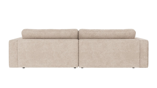 Beige tvåsitsig soffa med låg rygg och mjuka dynor, vy bakifrån