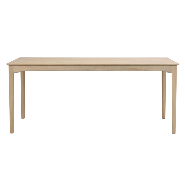 Matbord i ljust trä med raka ben och enkel skandinavisk design