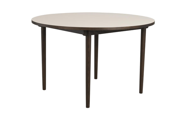 Runt matbord med ljus skiva och mörka träben, modern skandinavisk design