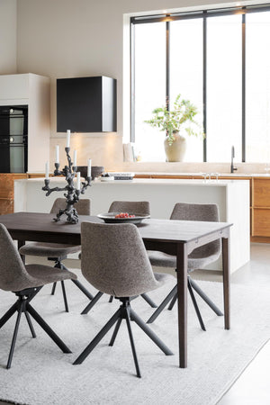 Modernt matbord med grå stolar i öppen planlösning med vitt kök och stora fönster