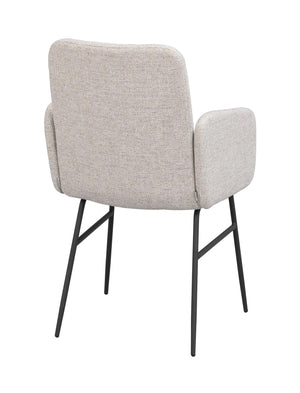 Stoppad karmstol med beige klädsel och svarta metallben, sedd bakifrån