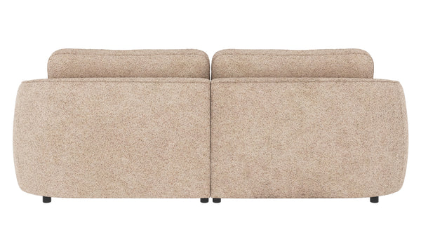 Beige tvåsitssoffa i teddy-tyg med rundade former, sedd bakifrån med två lösa ryggkuddar