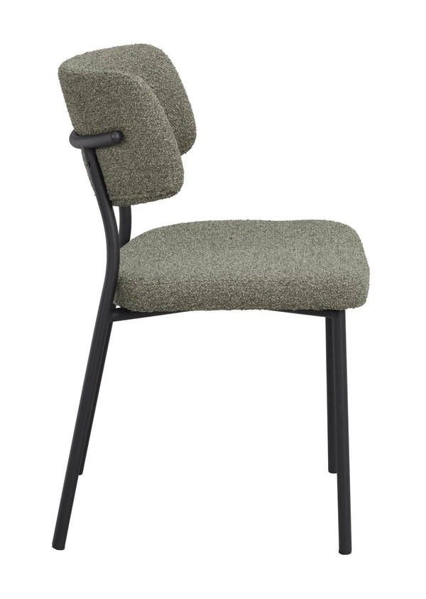 Grön stol med svart metallstomme och boucléklädsel i sidovy