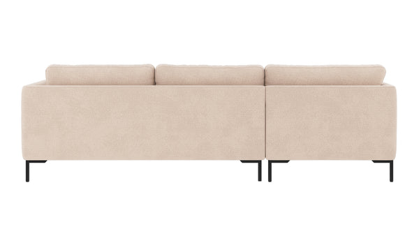 Beige soffa med schäslong och tre dynor, svarta metallben, baksida synlig mot vit bakgrund